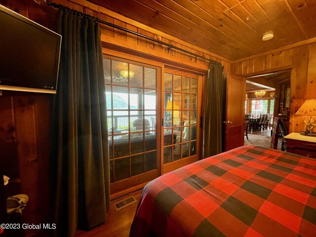 9667 Lake Shore Dr, Hague, NY 12836 - bedroom featuring wooden walls, wood ceiling, and wood finished floors