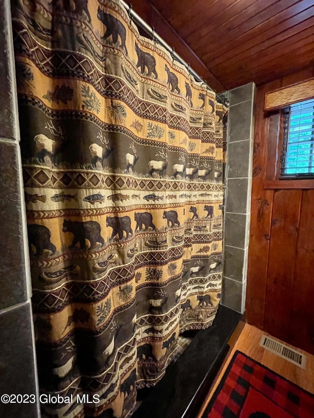 9667 Lake Shore Dr, Hague, NY 12836 - full bath featuring wooden ceiling and a shower with curtain