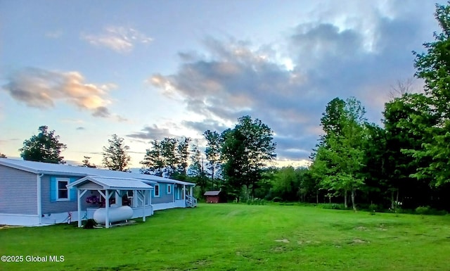 612 Oswegatchie Rd, Palatine, NY 13428 - yard at dusk featuring a lawn