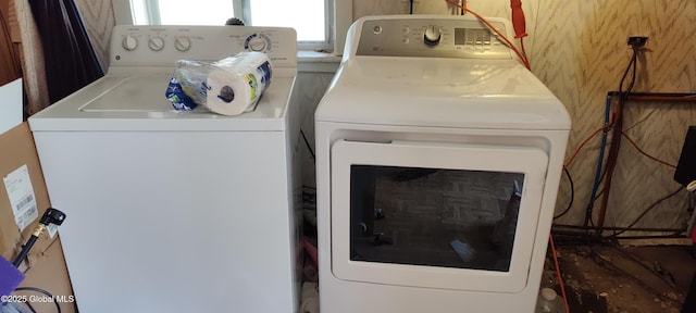 laundry room with separate washer and dryer and laundry area