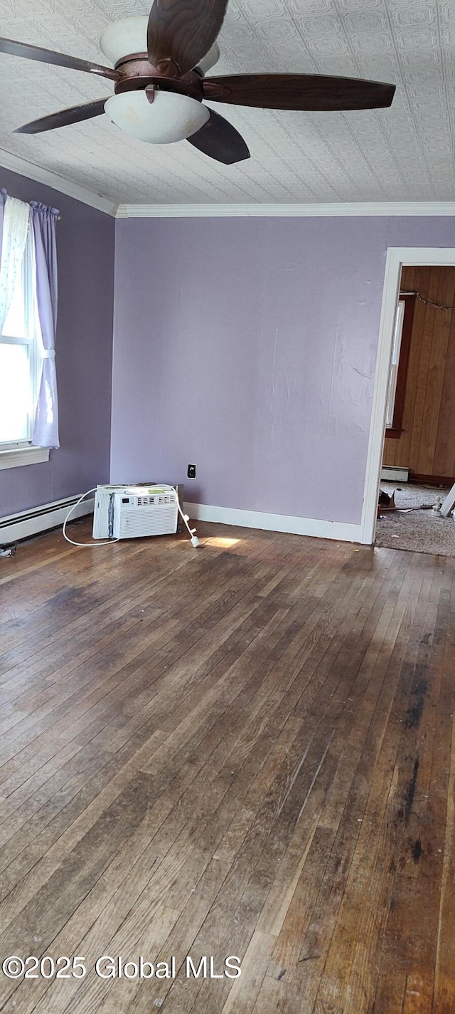 spare room featuring ornamental molding, baseboards, a ceiling fan, and hardwood / wood-style floors