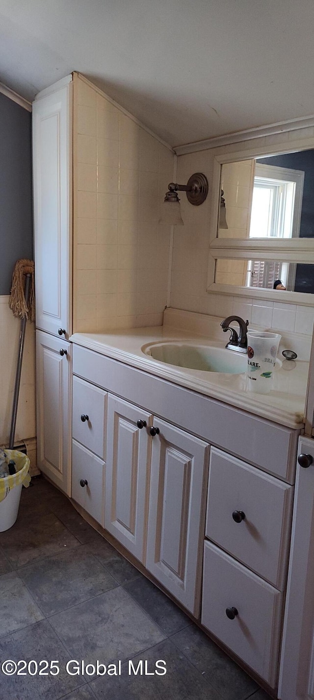 bathroom with crown molding and vanity