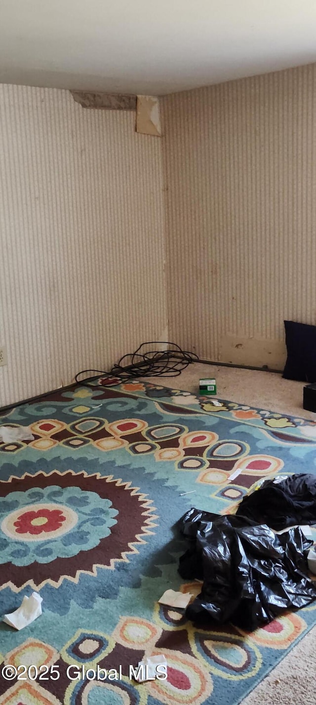 carpeted bedroom with wallpapered walls