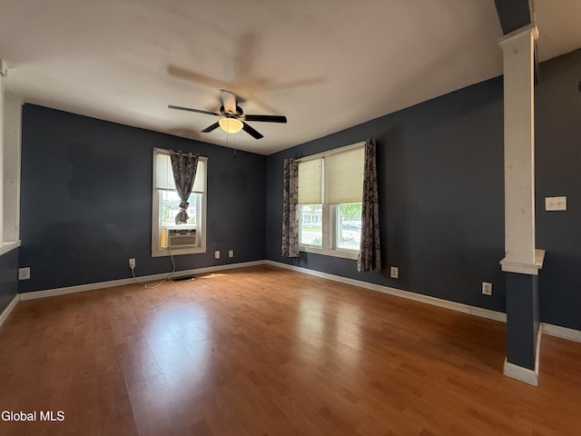 294 Main St, Hudson Falls, NY 12839 - spare room featuring ornate columns, a ceiling fan, wood finished floors, and cooling unit