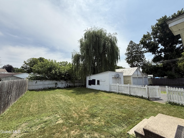 294 Main St, Hudson Falls, NY 12839 - fenced backyard featuring an outdoor structure and a detached garage