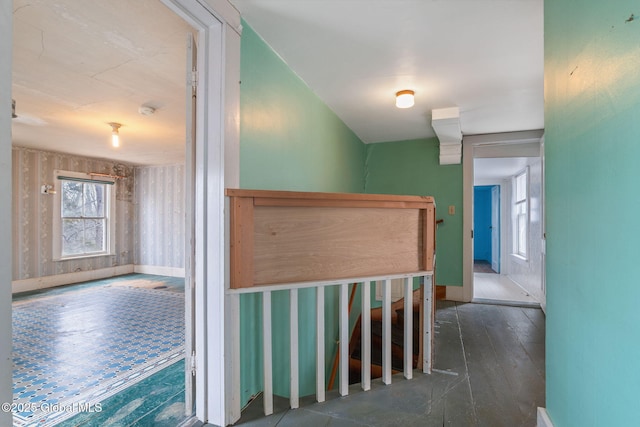 hall featuring baseboards and wood finished floors