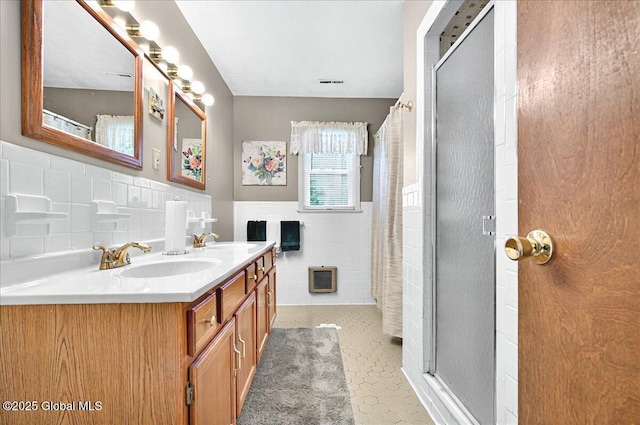 53 Harmon Rd, Glenville, NY 12302 - full bath featuring tile walls, a shower with shower curtain, double vanity, a wainscoted wall, and tile patterned floors