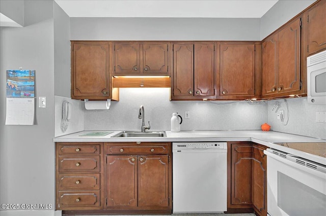 53 Harmon Rd, Glenville, NY 12302 - kitchen with white appliances, a sink, light countertops, tasteful backsplash, and brown cabinets