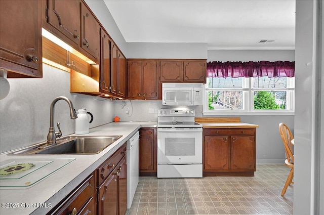53 Harmon Rd, Glenville, NY 12302 - kitchen with white appliances, light countertops, a sink, baseboards, and tasteful backsplash