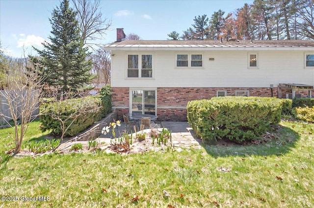 53 Harmon Rd, Glenville, NY 12302 - back of property featuring a chimney, brick siding, a lawn, and a patio