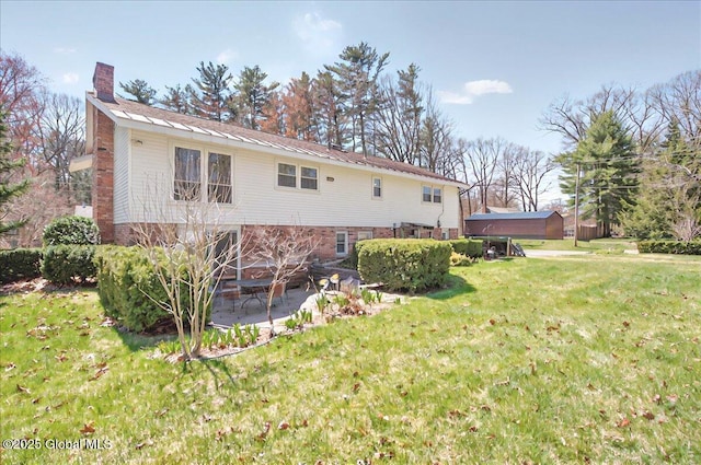53 Harmon Rd, Glenville, NY 12302 - rear view of property with a patio, a chimney, and a lawn