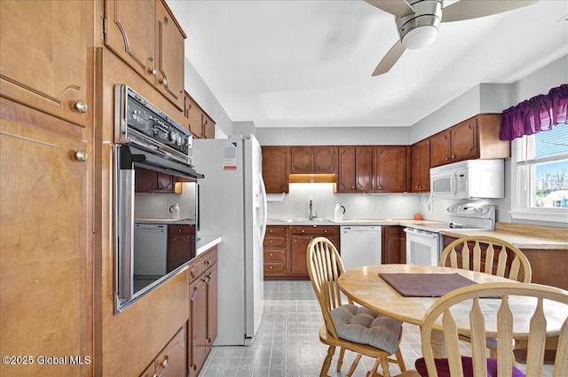 53 Harmon Rd, Glenville, NY 12302 - kitchen with white appliances, a ceiling fan, a sink, light countertops, and light floors