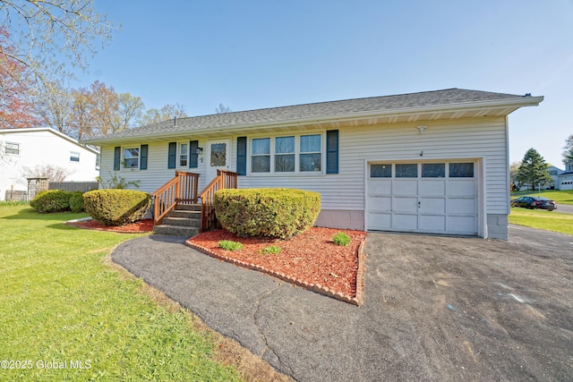 ranch-style home featuring a garage, driveway, and a front lawn