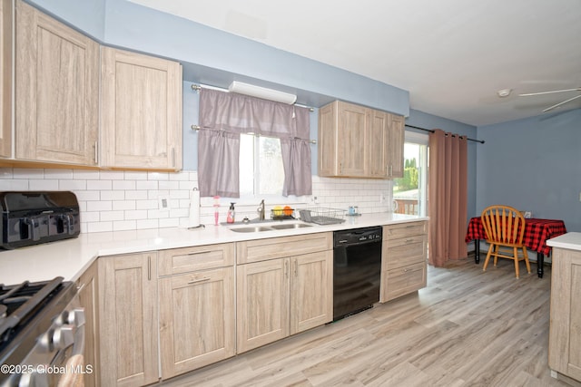 kitchen with light brown cabinetry, light wood-type flooring, tasteful backsplash, a sink, and dishwasher