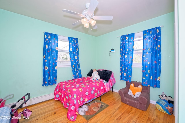 bedroom featuring baseboards, ceiling fan, and hardwood / wood-style floors
