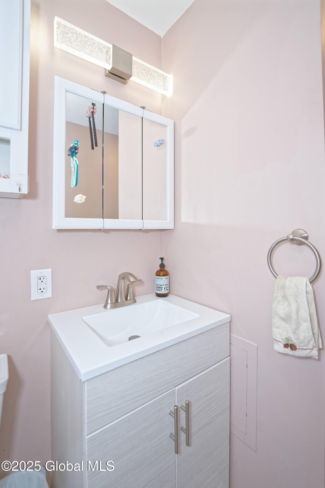bathroom with toilet and vanity