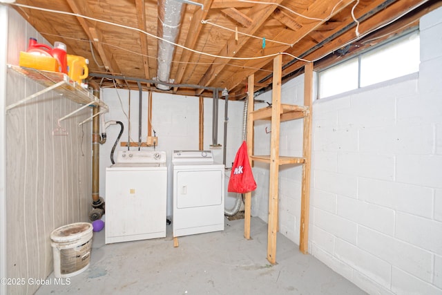 below grade area featuring independent washer and dryer and concrete block wall