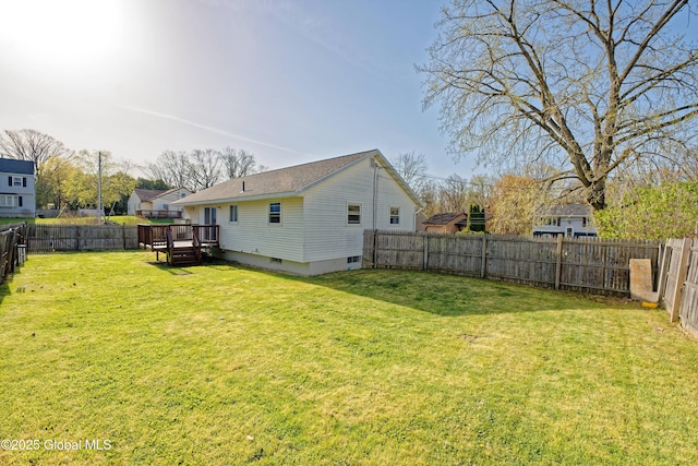back of house with a lawn, a wooden deck, and a fenced backyard