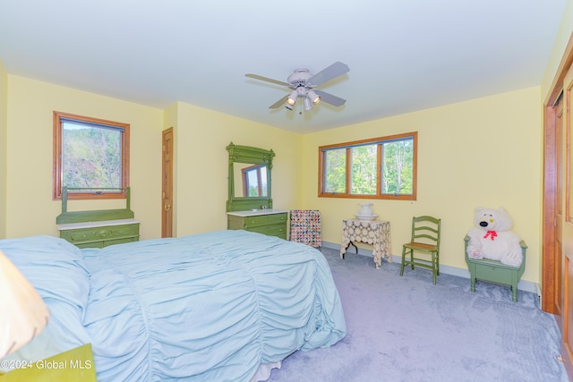 bedroom featuring baseboards, carpet floors, ceiling fan, and a closet
