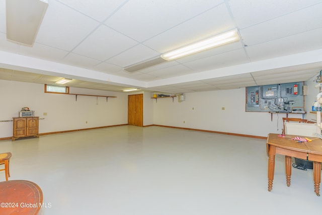finished below grade area featuring baseboards and a paneled ceiling