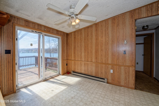 200 Summit Lake Rd, Argyle, NY 12809 - carpeted spare room with wooden walls, a water view, a ceiling fan, and baseboard heating