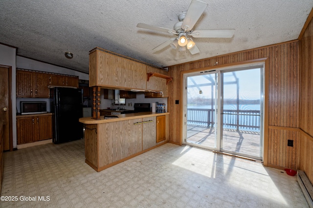 200 Summit Lake Rd, Argyle, NY 12809 - kitchen with wood walls, a water view, a baseboard heating unit, freestanding refrigerator, and a peninsula