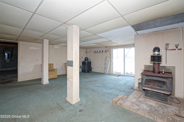 200 Summit Lake Rd, Argyle, NY 12809 - basement with carpet flooring, a wood stove, and a paneled ceiling