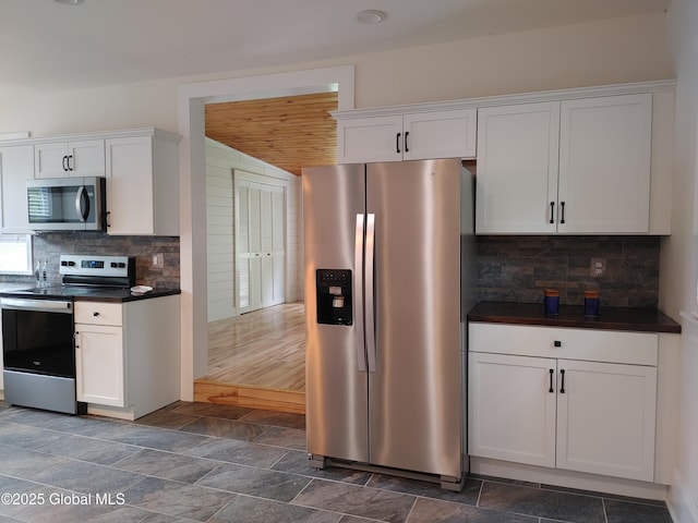 6 Father Jogues Pl, Ticonderoga, NY 12883 - kitchen featuring stainless steel appliances, dark countertops, white cabinets, decorative backsplash, and wood ceiling