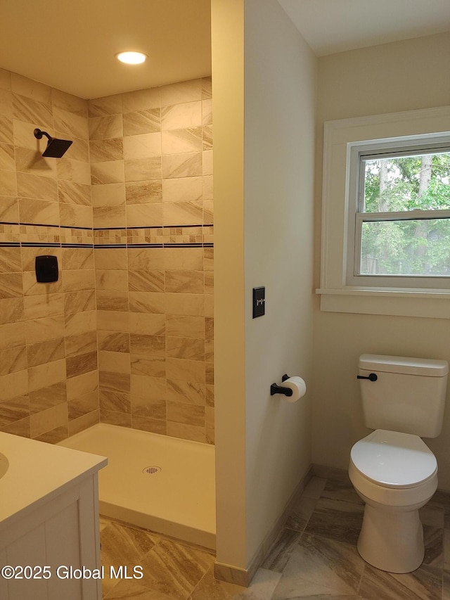 6 Father Jogues Pl, Ticonderoga, NY 12883 - bathroom with a tile shower, toilet, baseboards, and vanity