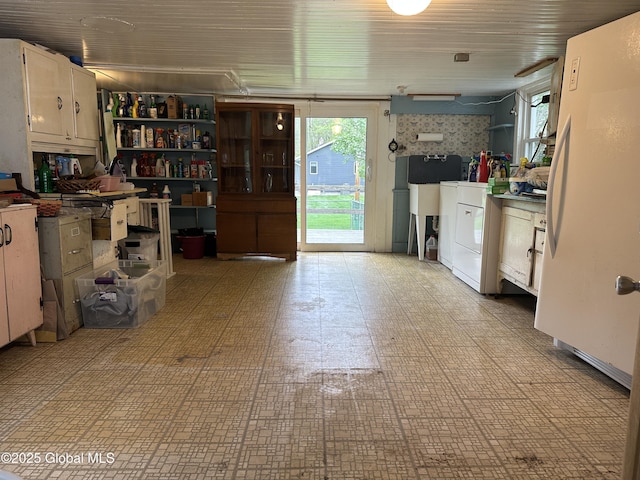 garage with washer / dryer and freestanding refrigerator