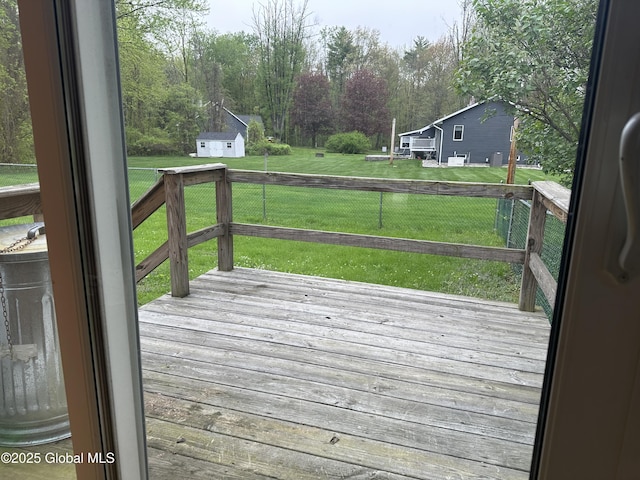 deck with a yard and an outbuilding