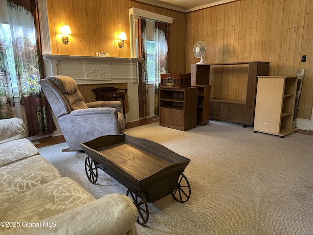 sitting room featuring wooden walls and light colored carpet