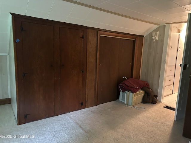 unfurnished bedroom featuring carpet flooring and vaulted ceiling