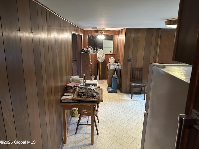 interior space featuring wooden walls and brick patterned flooring