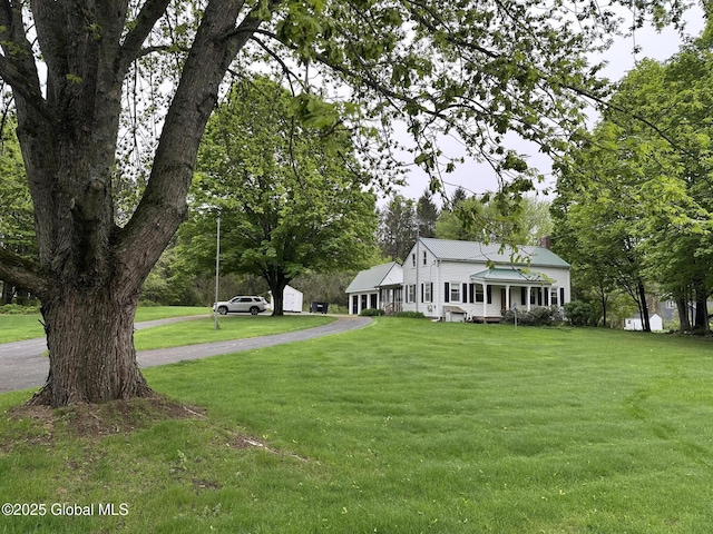 view of front of home featuring a front yard and asphalt driveway