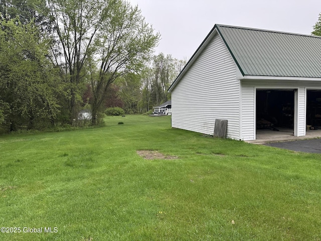 view of property exterior with a lawn and metal roof