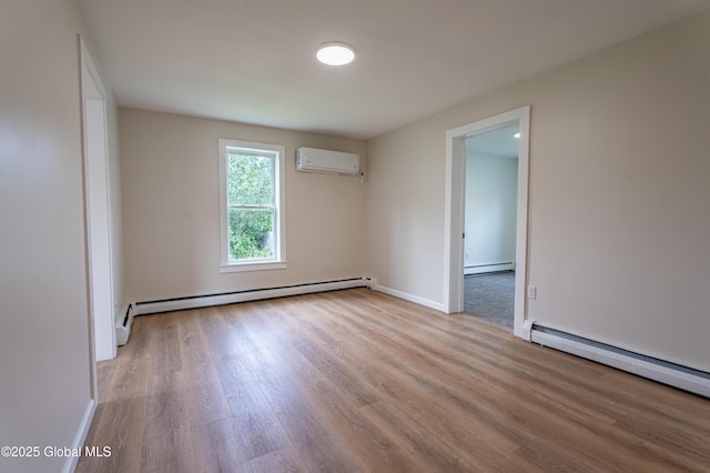 65 N Main St, Voorheesville, NY 12186 - spare room featuring a baseboard heating unit, a wall unit AC, a baseboard radiator, and wood finished floors