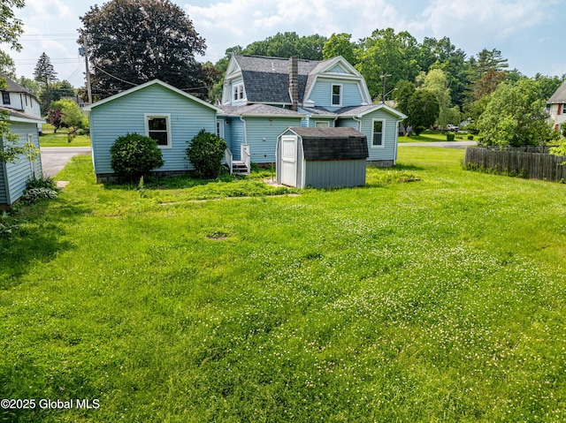 65 N Main St, Voorheesville, NY 12186 - back of house with a shed, roof with shingles, a lawn, and a gambrel roof