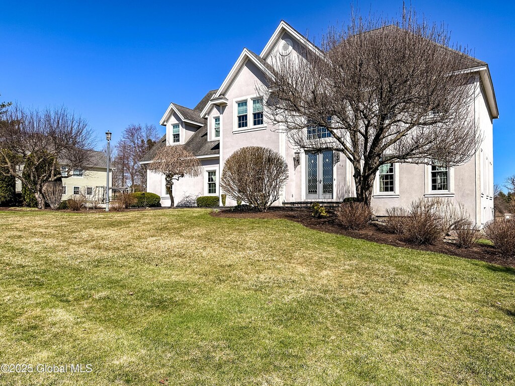 64 Masters Common S, Queensbury, NY 12804 - view of front of property featuring french doors, stucco siding, and a front yard