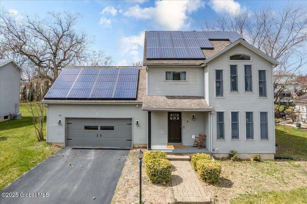 5 Musket March, Stillwater, NY 12118 - traditional home featuring roof with shingles, driveway, an attached garage, a front lawn, and solar panels