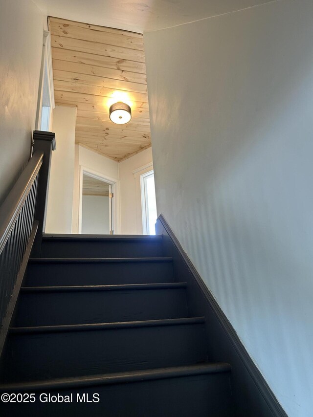 stairway with wooden ceiling