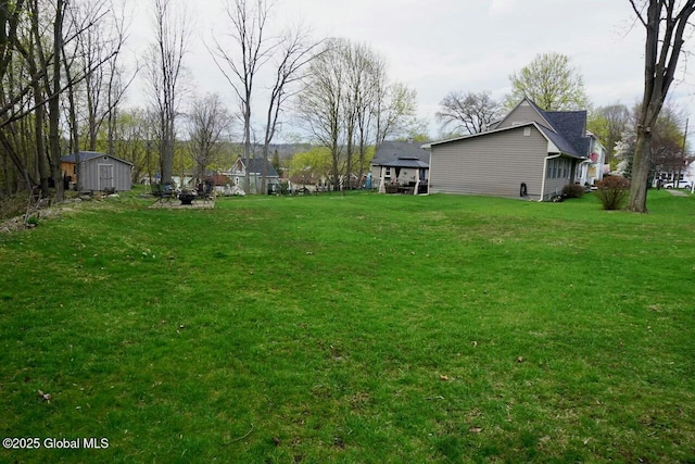 view of yard with an outbuilding and a storage shed