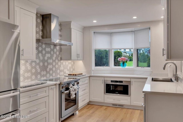 101 Kaydeross Park Rd, Saratoga Springs, Outside, NY 12866 - kitchen with wall chimney range hood, appliances with stainless steel finishes, a sink, light countertops, and tasteful backsplash