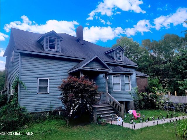 cape cod-style house with a chimney