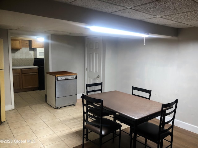 dining room with baseboards and a drop ceiling