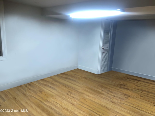 finished basement featuring baseboards and wood finished floors