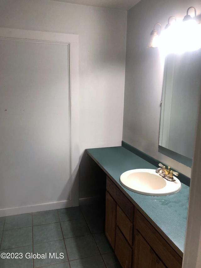 bathroom featuring vanity, baseboards, and tile patterned floors