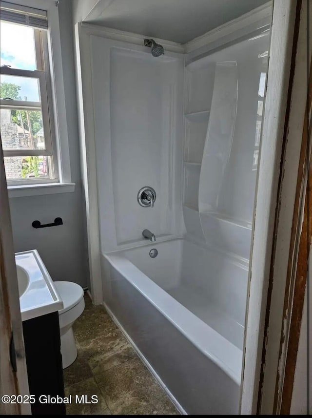 full bath featuring toilet, vanity, and bathing tub / shower combination