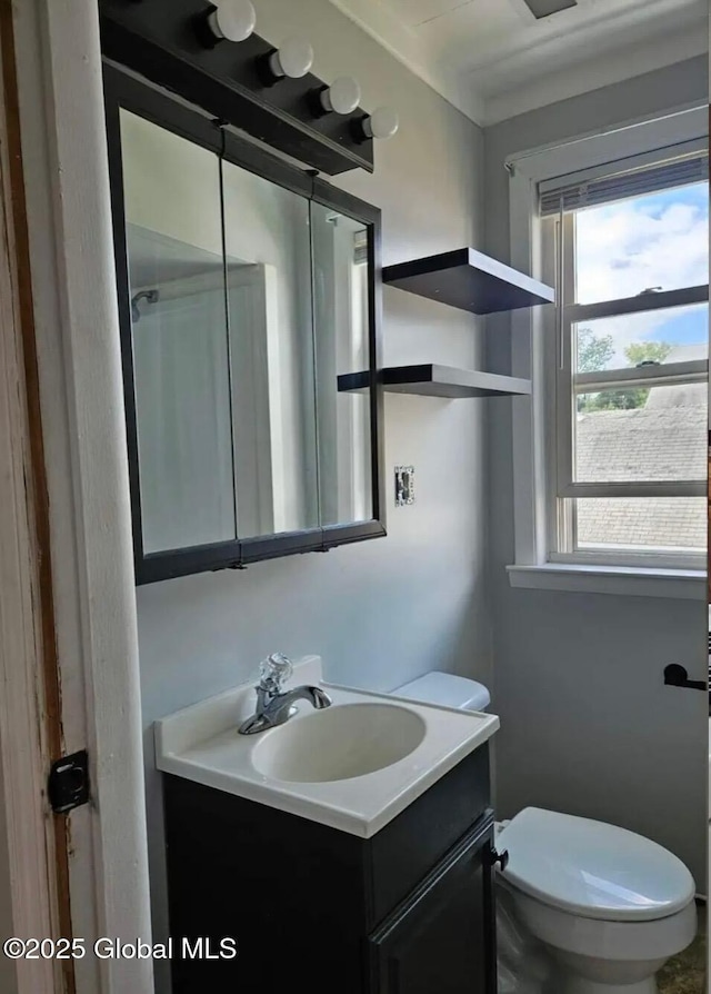 half bathroom featuring toilet and vanity