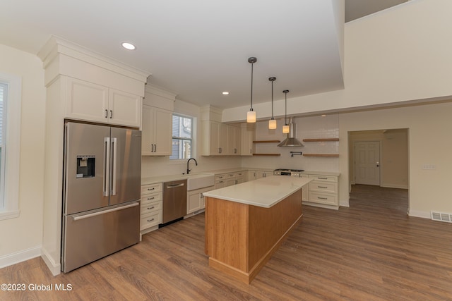 kitchen featuring light countertops, open shelves, visible vents, appliances with stainless steel finishes, and a sink